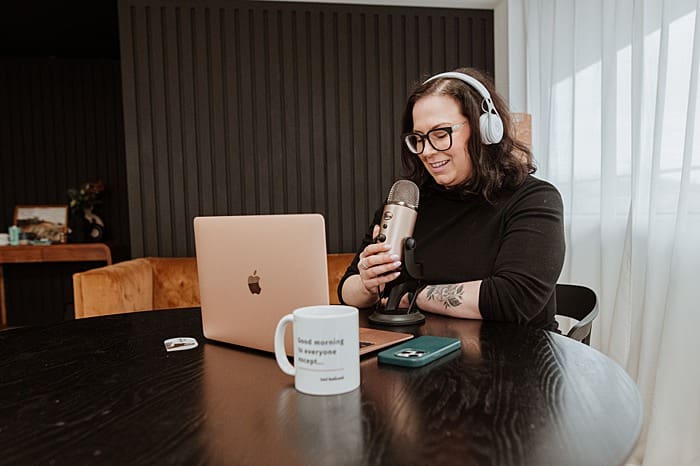 Creative entrepreneur working at desk during branding photo shoot