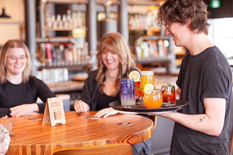 server at a local restaurant serving drinks to patrons during Vancouver branding session
