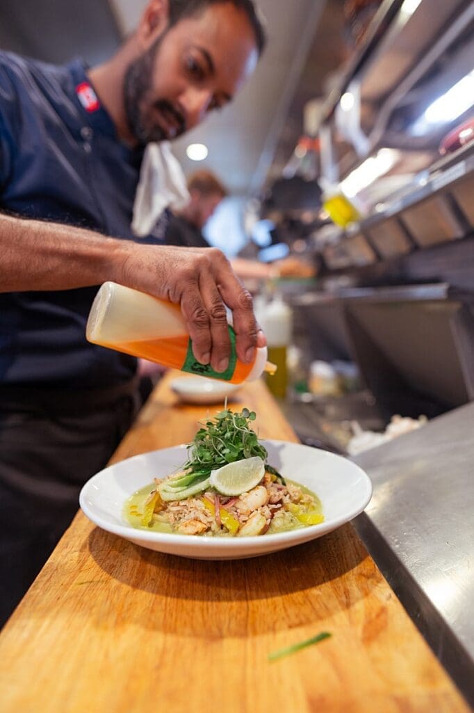 restaurant chef plating a dish during content shoot – hospitality content photography Vancouver