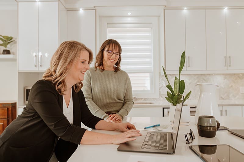 Entrepreneur reviewing brand photos on laptop — representing strategic use of visuals in marketing.